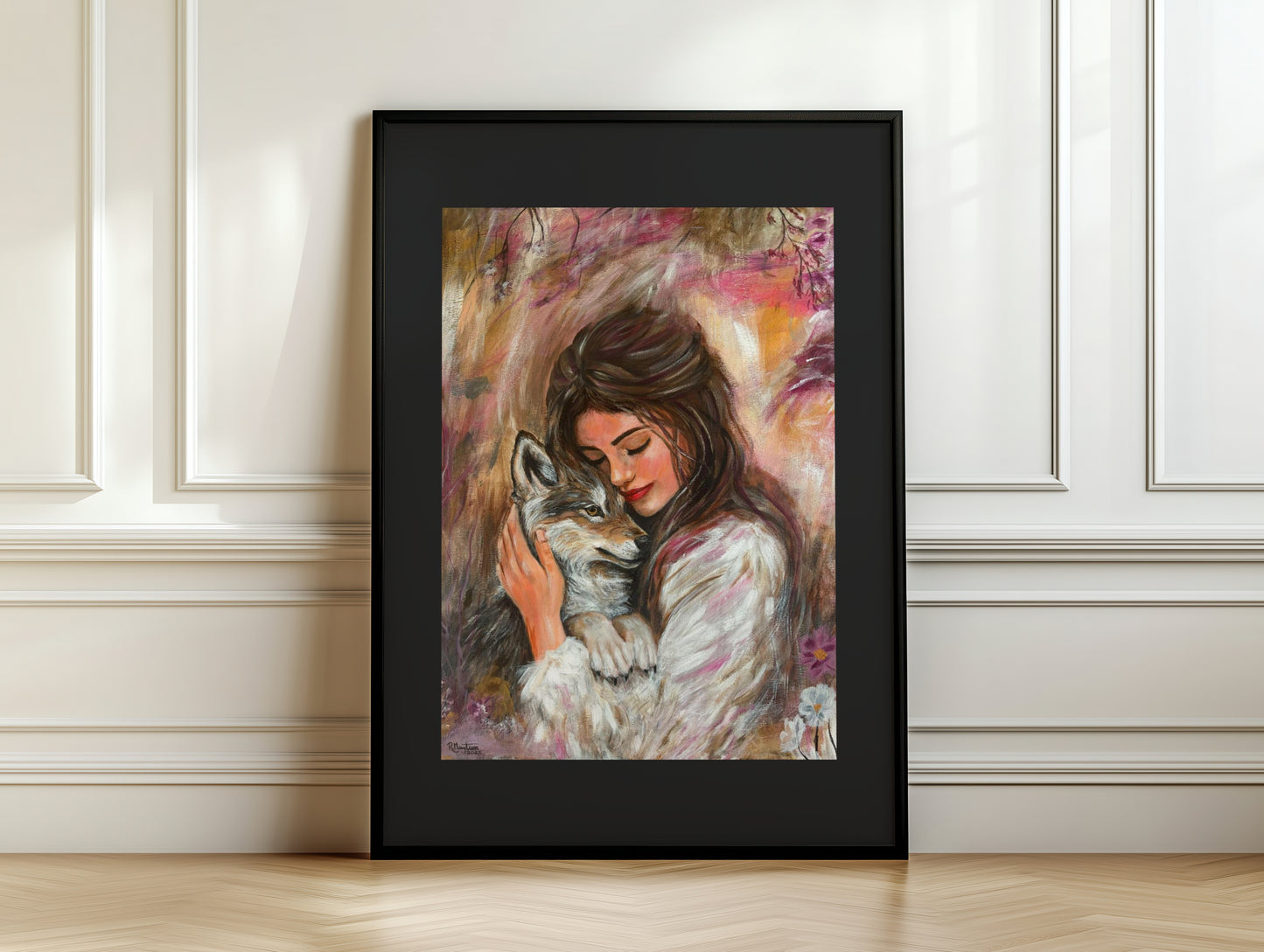 Framed artwork of a woman hugging a wolf against a white wall.