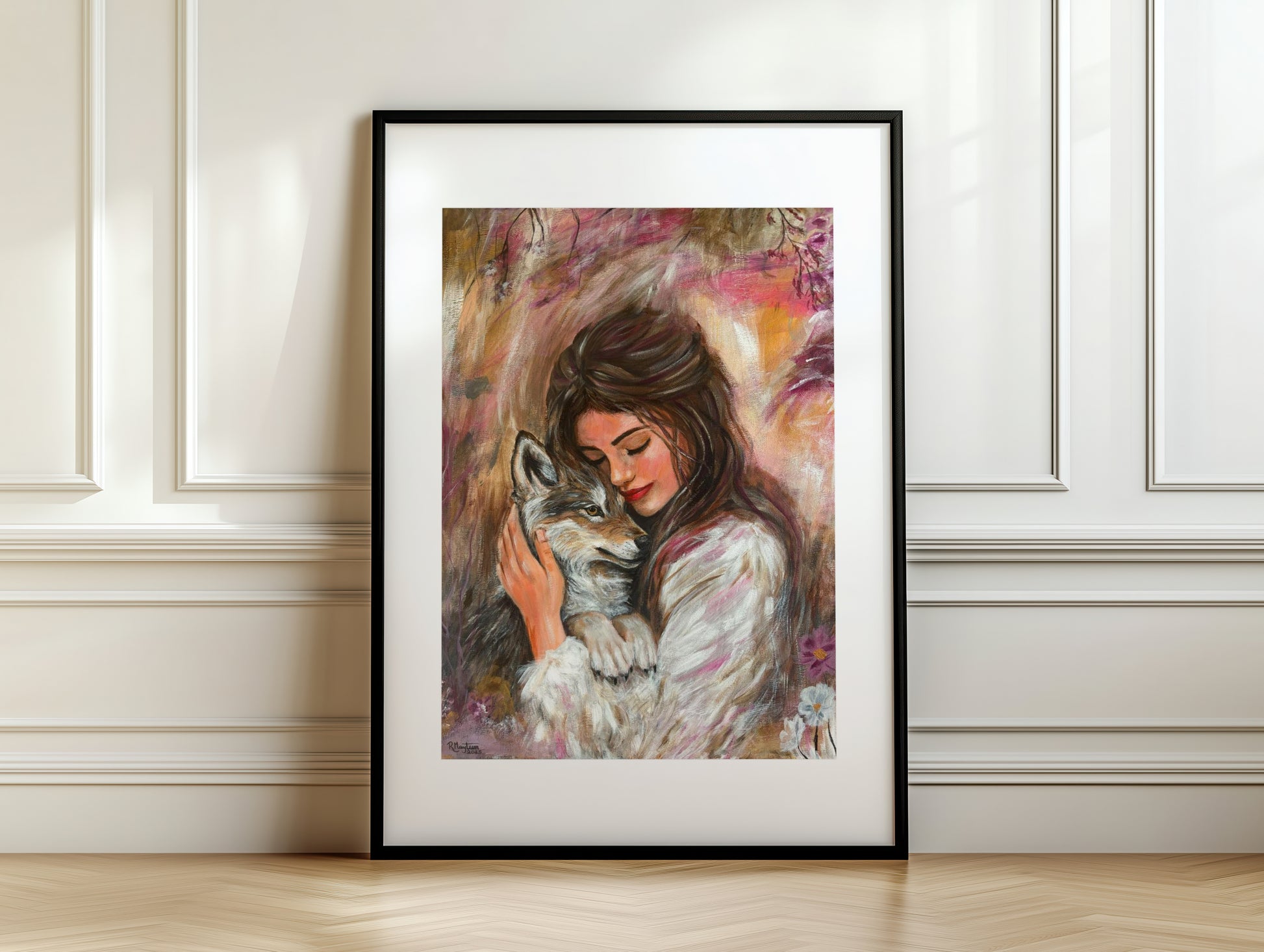 Framed artwork of a woman holding a wolf against a white wall.