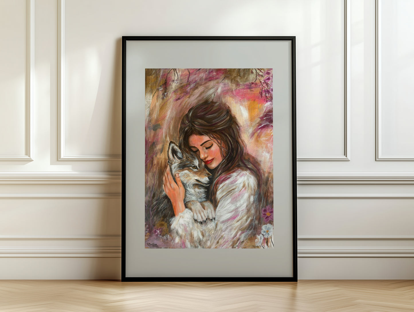 Framed artwork of a woman hugging a wolf against a white wall.